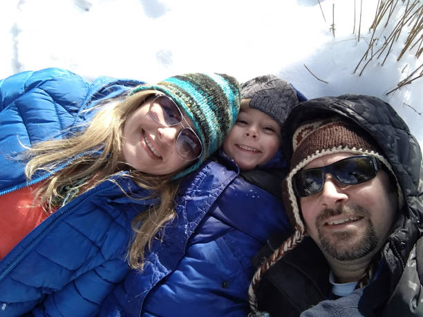 istock Happy family lying on the snow 1197344623