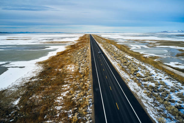 istock Driving Alone on a Winter Causeway 1197344942
