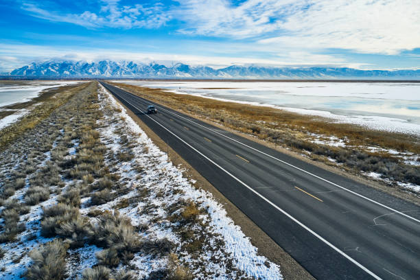 istock Driving Alone on a Winter Causeway 1197344943