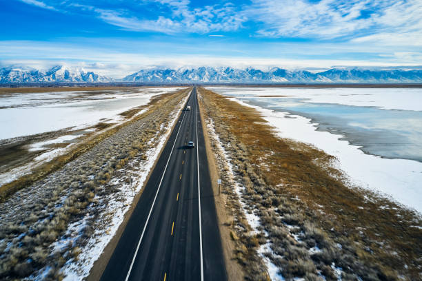 istock Driving Alone on a Winter Causeway 1197344978