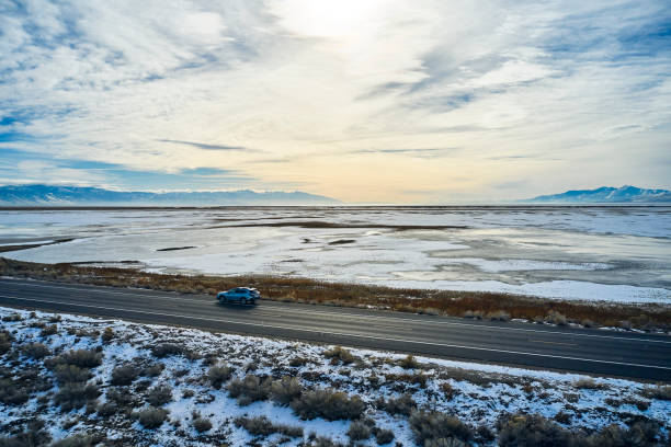 istock Driving Alone on a Winter Causeway 1197344982