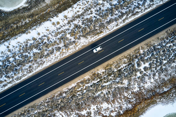 istock Driving Alone on a Winter Causeway 1197344995