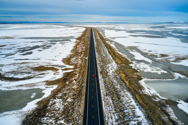 istock Driving Alone on a Winter Causeway 1197345012