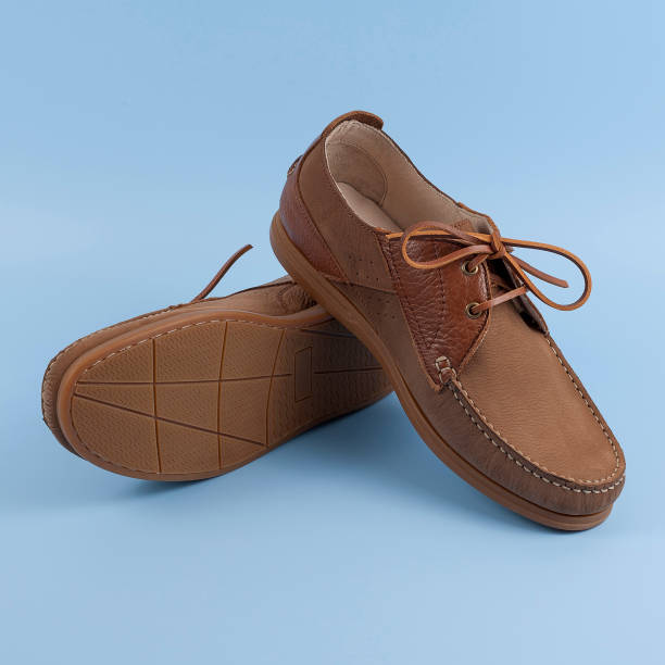 istock Men's brown moccasins, loafers isolated on blue background. 1197345982