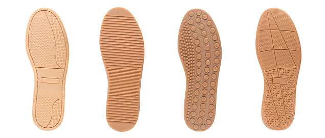 Four brown shoe sole in row. White background.