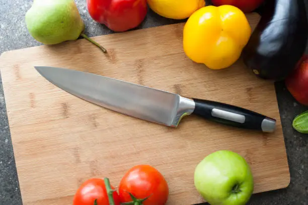 Still life of vegetables and kitchen-knife on cutting board