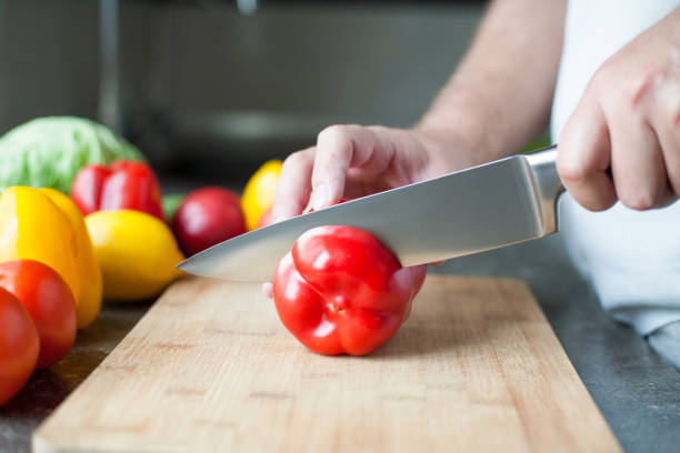 istock Salad preparation - cutting red pepper into pieces 1197346101