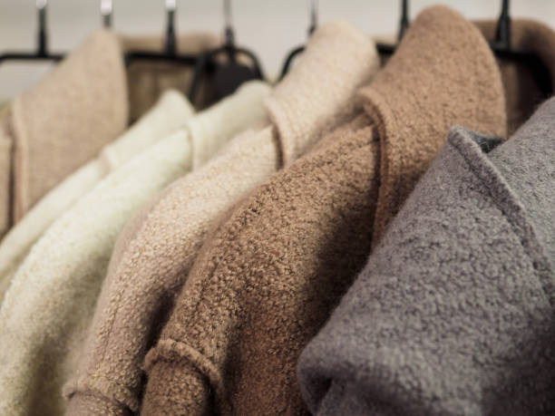 istock Several wool coats hanging on a hanger in the store 1197346347