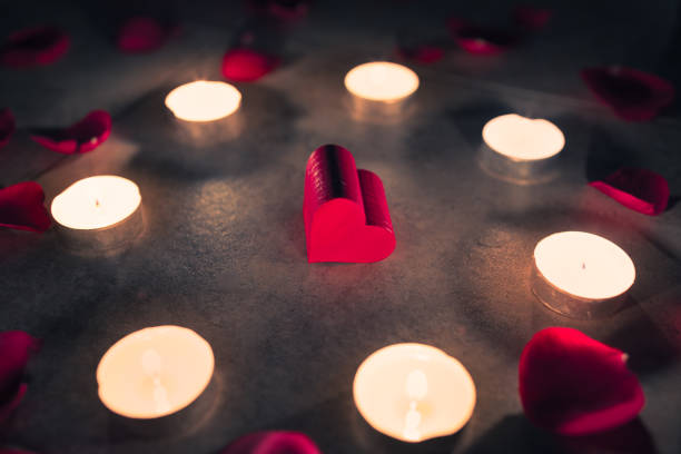 istock Heart candle light red roses in a romantic night setting. 1197346358