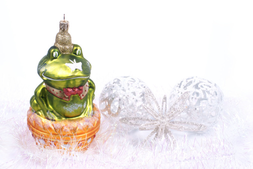 ceramic frog with crown and golden ball near waterside- focus on ball