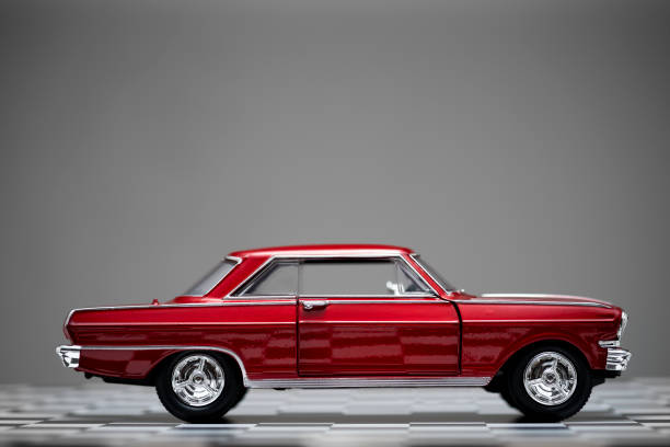 istock Side view of a red colored classic toy model car. 1197347562
