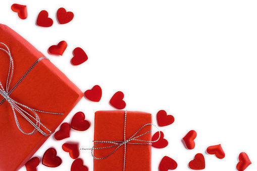 Festive composition from two red gift boxes and hearts scattered and isolated on white background, valentines day concept, copy space for text, flatlay