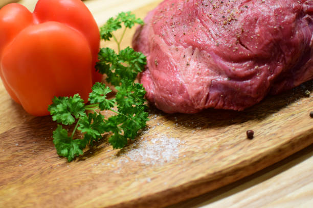 Beef tenderloin on a cutting board.