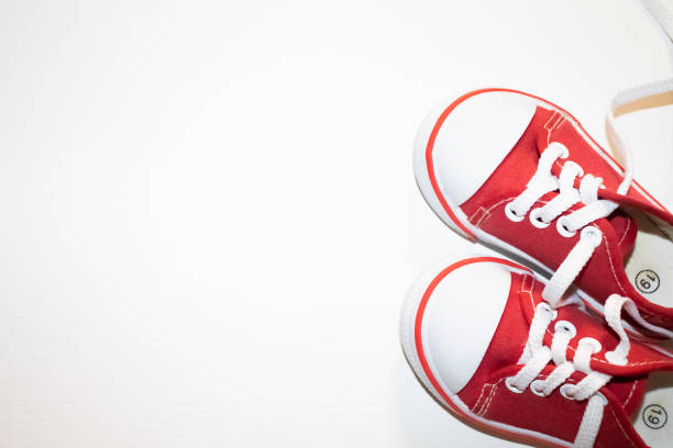 istock Red sneakers top view close up isolated on white background 1197359339