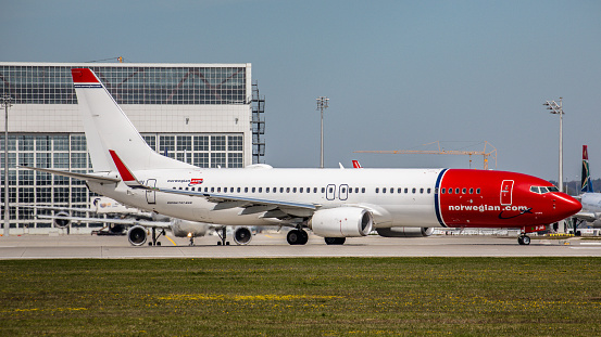 Munich, Germany - April 23, 2019: A Boeing 737-8JP from Norwegian Air is getting ready to take off at Munich Airport. The aircraft with registration EI-FJU has been in service for the Norwegian airline since August 2016.