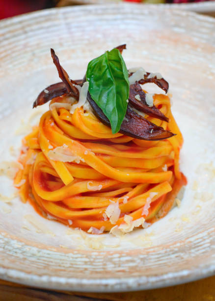 istock Spaghetti in a plate with a leaf of basil 1197366640