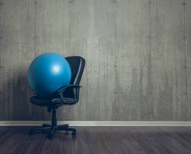 Fitness ball on top of an office chair Fitness ball on top of an office chair ergonomics photos stock pictures, royalty-free photos & images