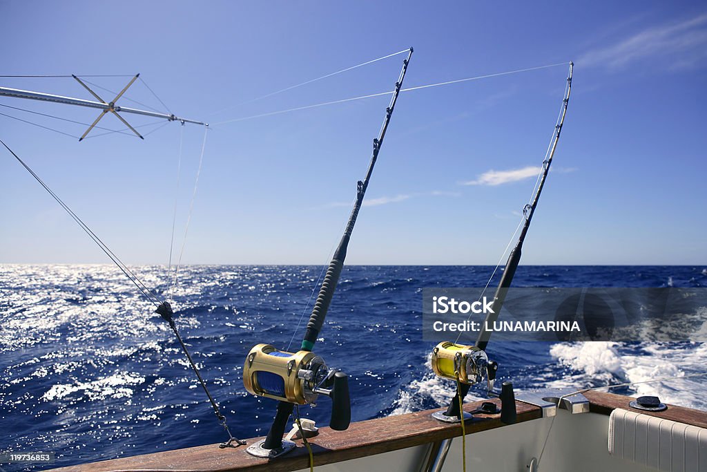 Angler boat on an ocean with two fishing rods Angler boat big game fishing in saltwater ocean Beach Stock Photo