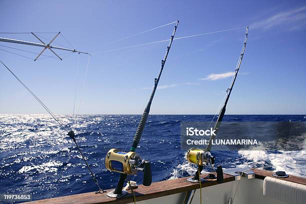 Angler Boat On An Ocean With Two Fishing Rods Stock Photo - Download Image Now - Beach, Beauty In Nature, Blue