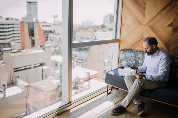 istock Businessman working in hotel lobby 1197368648