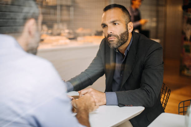 istock Two businessman in coffee shop 1197368776