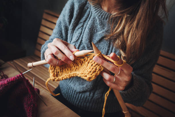 istock Close up on woman's hands knitting 1197373056