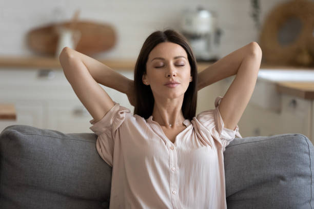 istock Young mindful woman relaxing on comfortable couch at home. 1197373162