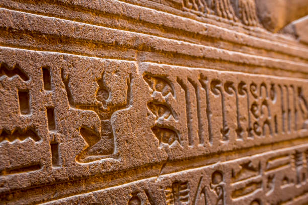 istock Ancient egyptian hieroglyphs on the wall in Horus Temple in Edfu, Egypt 1197373430