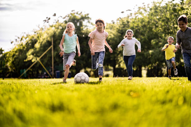 istock Kids playing at the field 1197373471
