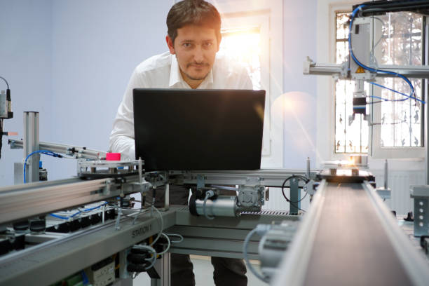 istock Engineer is working on laptop to programming PLC of smart factory 1197375062