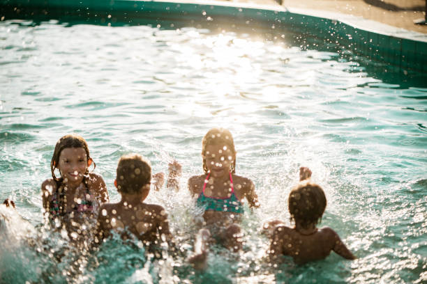 istock Group of children playing in the pool 1197375319