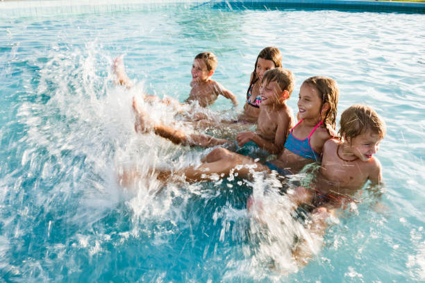 istock Group of children playing in the pool 1197375998