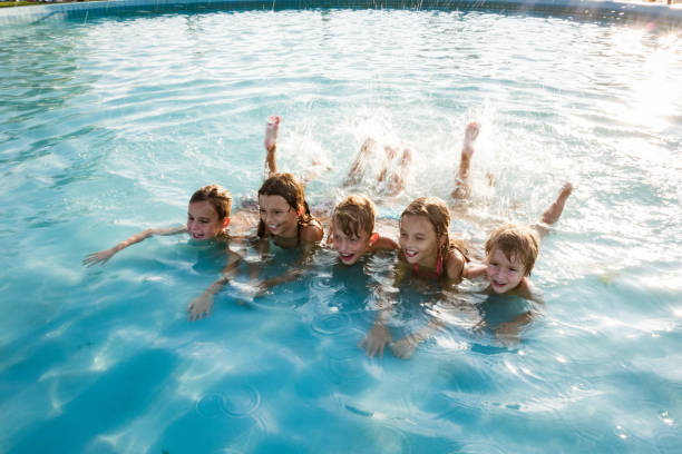 istock Group of children enjoying in the pool 1197376054