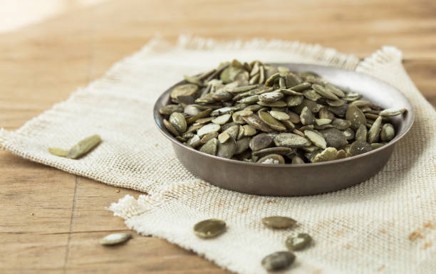 istock Pumpkin seeds (peeled seeds) (Collection of various nuts). Close-up. Isolated on white background. 1197387389