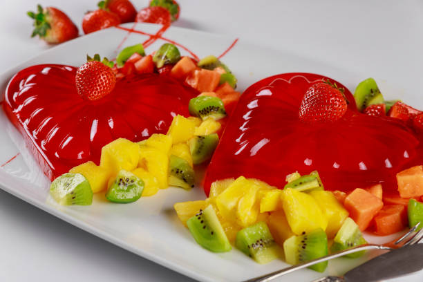 istock Red gelatin heart shape with chopped fresh fruit on a white background. 1197387454