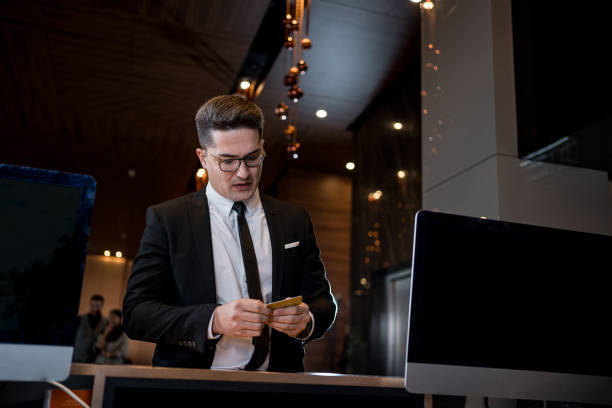 istock Businessman waiting at a hotel reception 1197388842