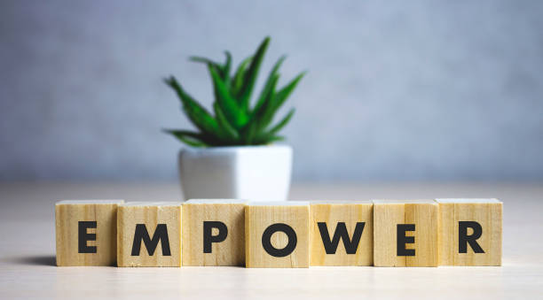 istock empower word written on wood block. empower text on table, concept. 1197389161