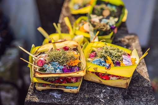 Offerings to gods in Bali with flowers, food and aroma sticks.