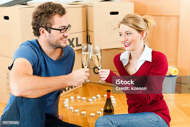 Young Couple Having Break While Moving In Stock Photo - Download Image Now - Adult, Alcohol - Drink, Apartment