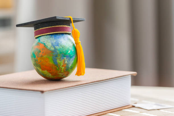 istock Education to learn study in world. Graduated student studying abroad international idea. Master degree hat on top globe book. Concept of graduate educational for long distane learning anywhere anytime 1197393206