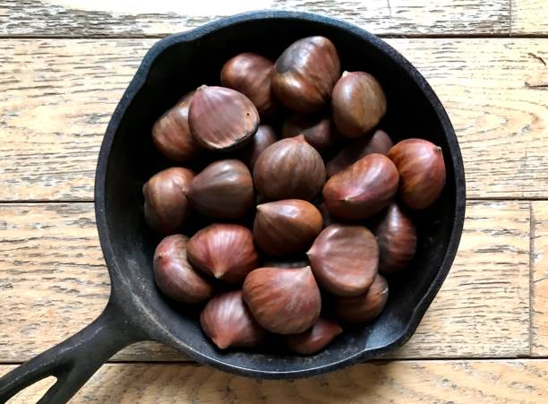 Chestnuts in Pan Overhead view of whole chestnuts in a cast iron pan. 8564 stock pictures, royalty-free photos & images