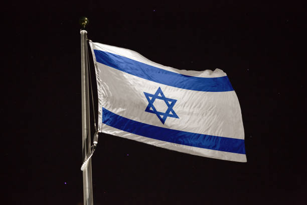 istock Israel flag blowing in the wind at night 1197396272