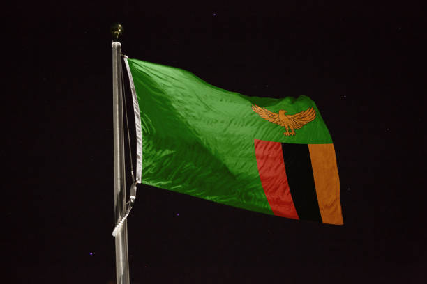 Zambia flag blowing in the wind at night flag blowing in the wind at night zambia flag stock pictures, royalty-free photos & images