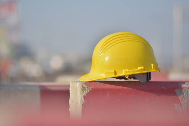 istock Yellow helmet on barrier Engineering road construction 1197397959
