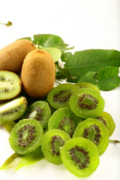 istock Kiwi fruit slices on white background 1197398804