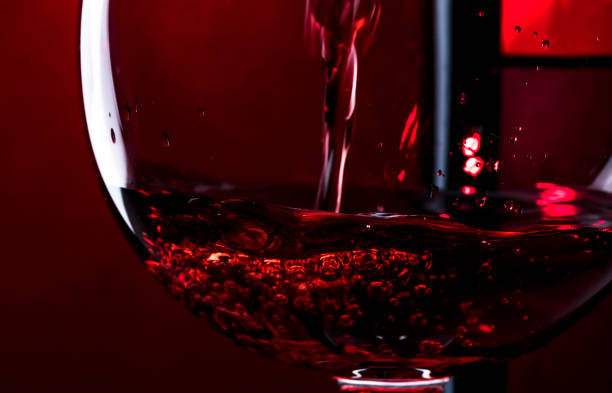 istock Red wine on red black background, abstract splashing. Macro shot 1197406136