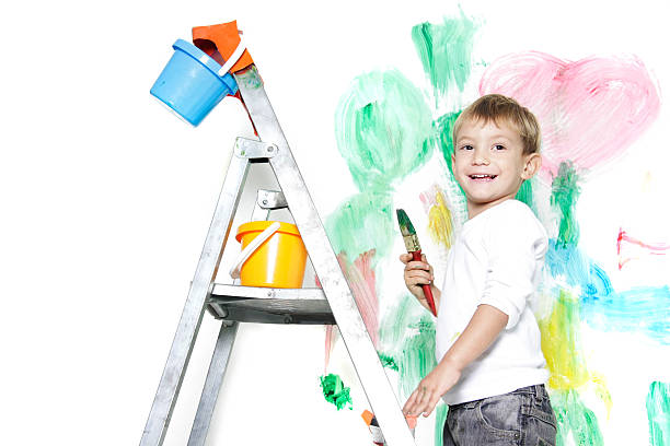istock happy young boy painting over white 119740874