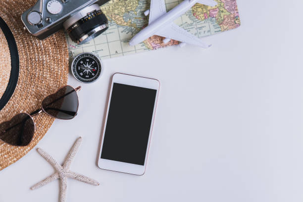 istock Empty screen smart phone with travel accessories and items on white background with copy space, Travel concept 1197409946