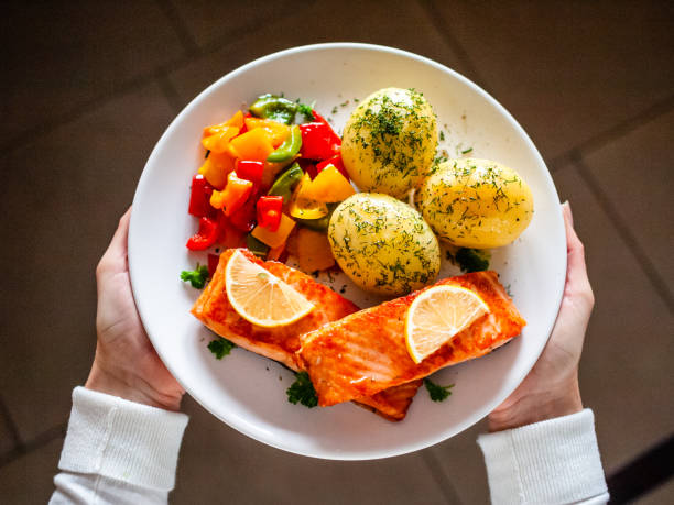 istock Grilled salmon, boiled potatoes and vegetables on kitchen table 1197411880