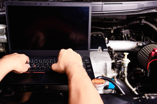 istock Professional car repair or maintenance mechanic engine working service with laptop computer 1197414595